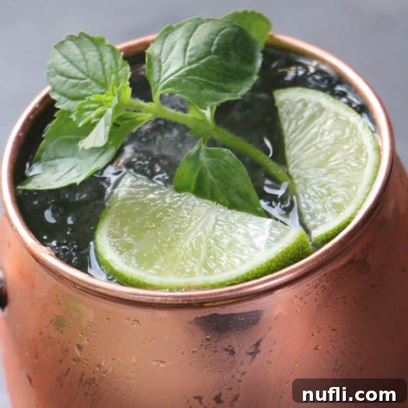 Mastering Ginger Beer Mixology 4 Classic Moscow Mule in a copper mug with mint leaves and lime wedges