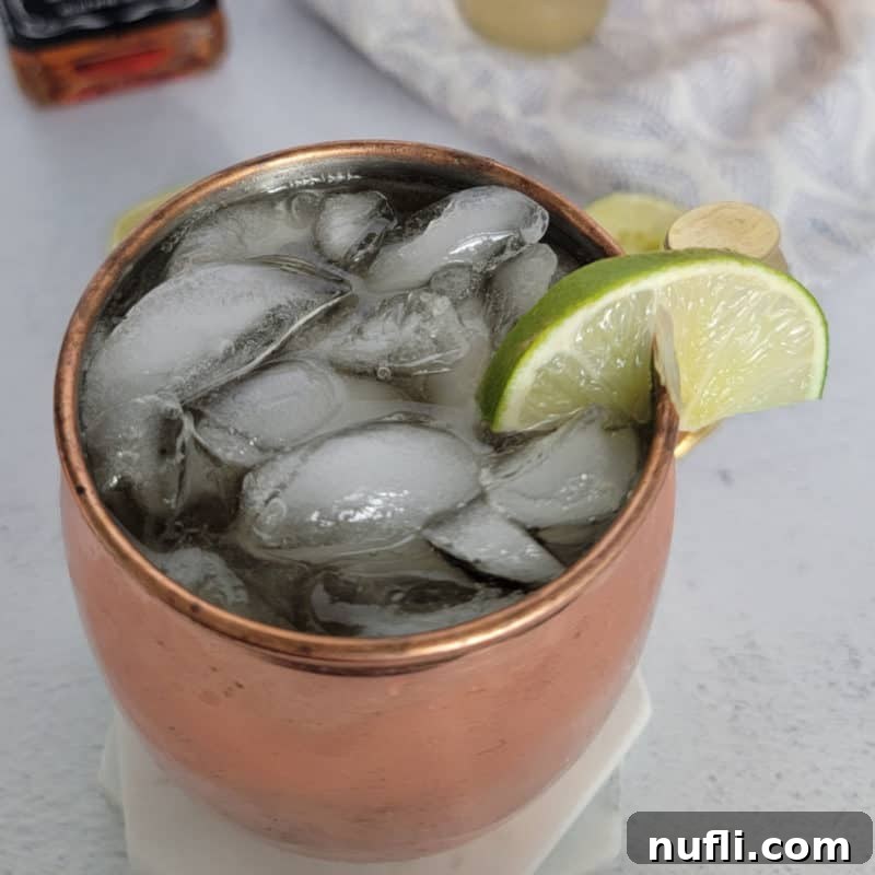 Mastering Ginger Beer Mixology 6 Whiskey Mule in a copper mug with lime wedge