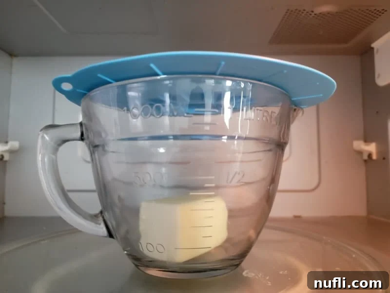 microwave splatter cover for butter over a glass bowl