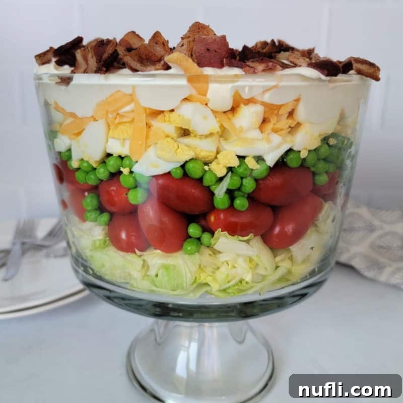 A beautifully layered 7-Layer Salad displayed in an elegant serving dish.
