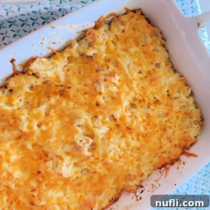 Cracker Barrel Hashbrown Casserole baked golden brown in a white casserole dish.