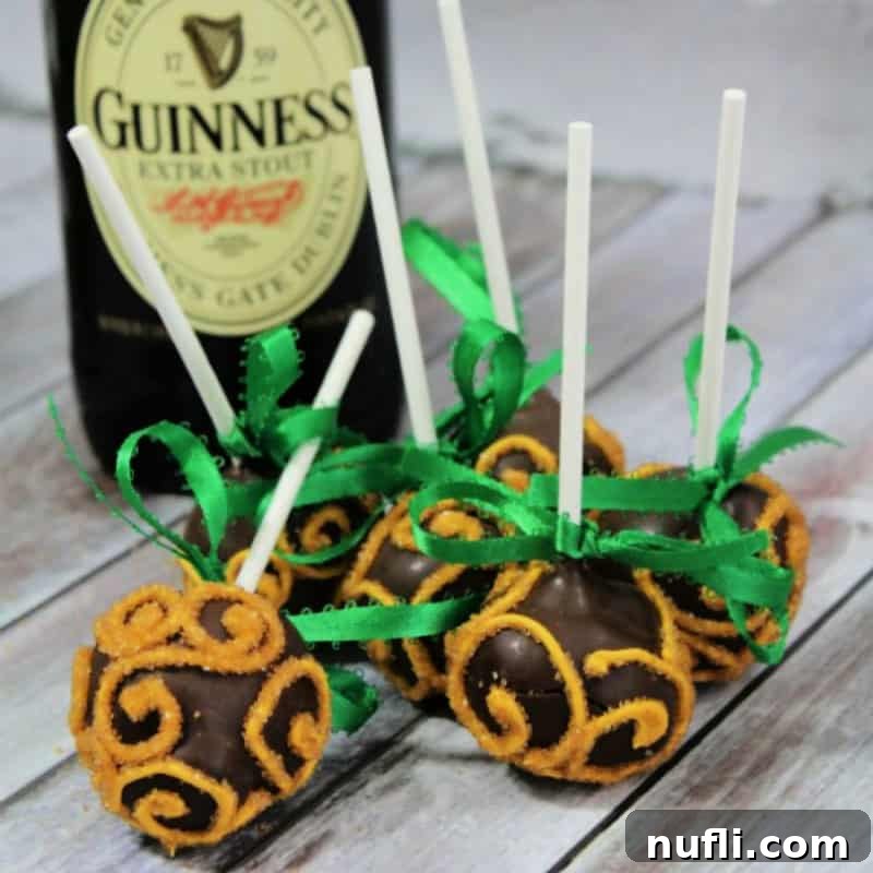 Guinness Cake Pops by a bottle of Guinness