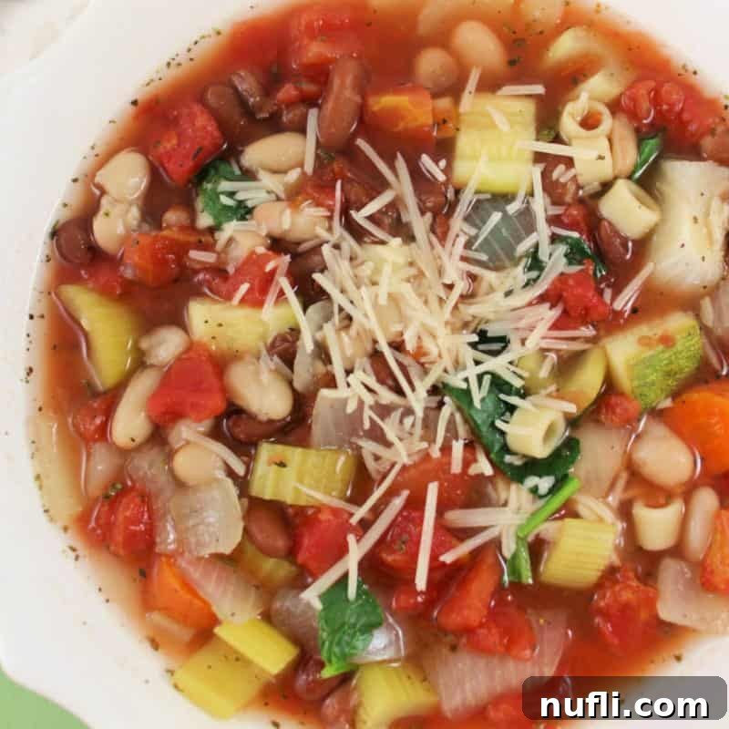 Olive Garden's Best, Made Easy at Home 4 A bowl of homemade Olive Garden Minestrone soup topped with grated Parmesan cheese