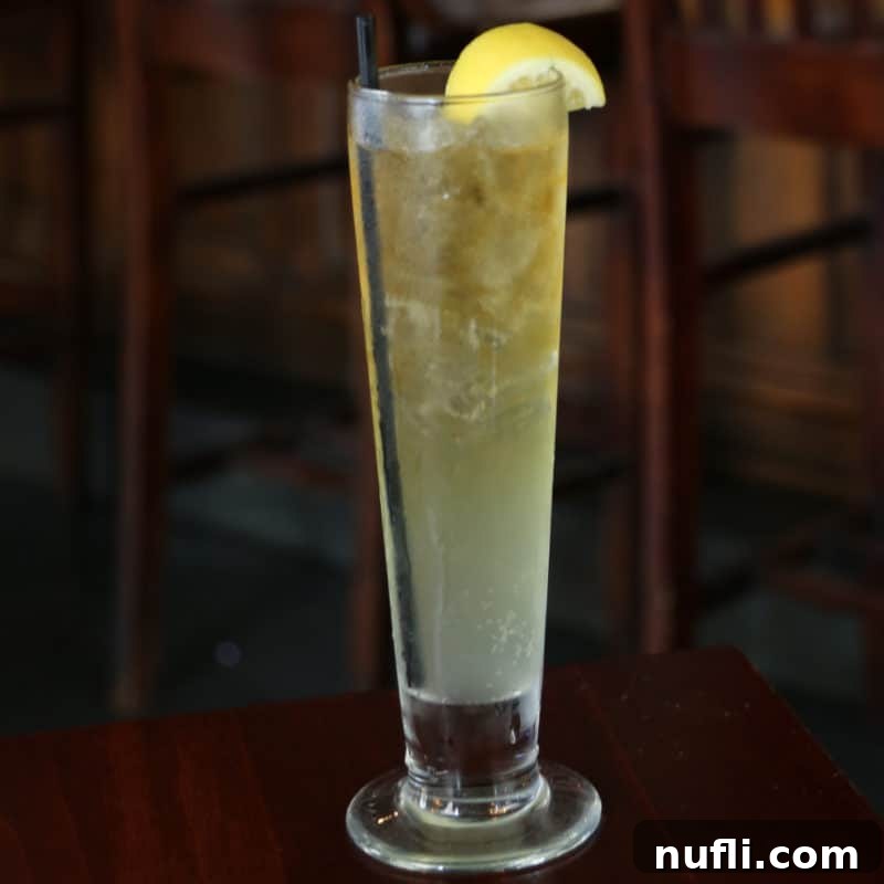 Lynchburg Lemonade in a tall glass with a lemon wheel