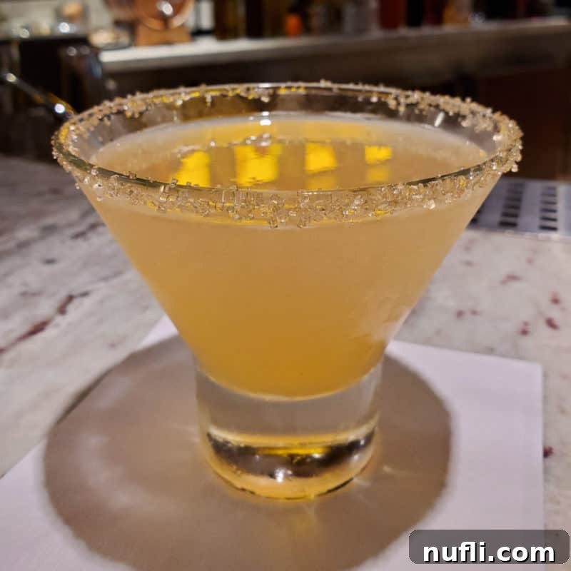 Alchemist Sidecar in a stemless martini glass with sugared rim