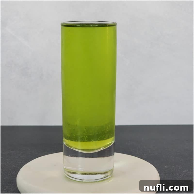 Broken Down Golf Cart green shot in a glass on a coaster