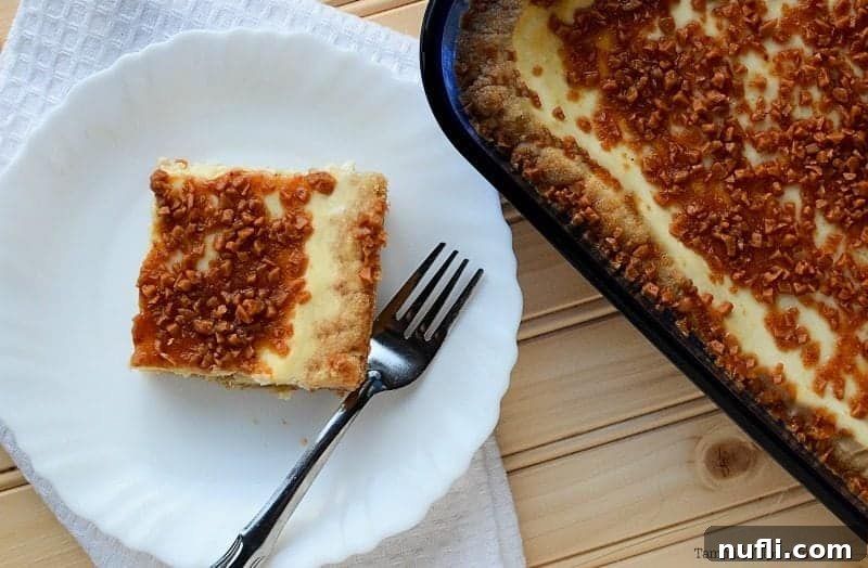 Creme Brulee bar on a white plate with a fork next to the baking dish