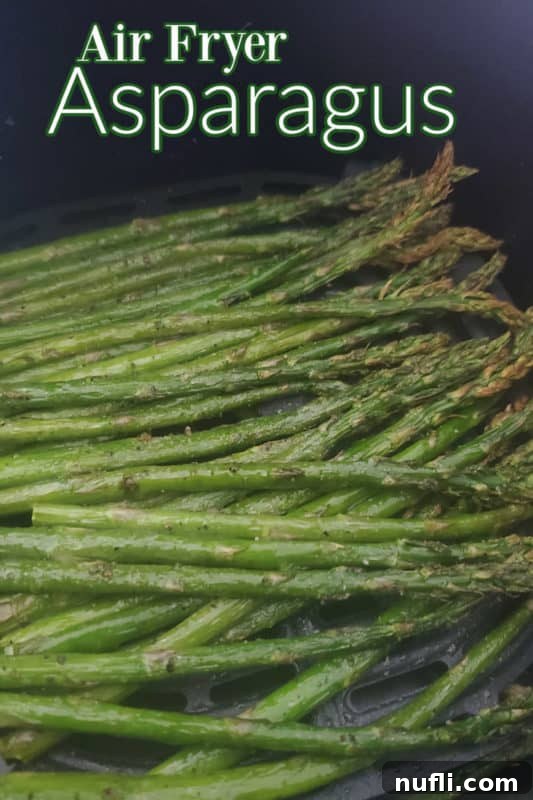 30 Simple Flavorful Vegetarian Air Fryer Dishes 15 Air Fryer Asparagus over a bundle of asparagus in the air fryer