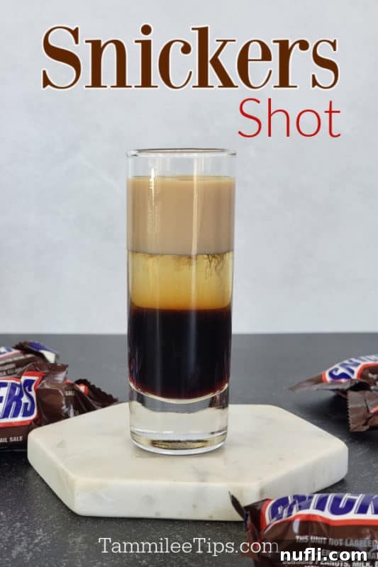 Snickers Shot text over a layered snickers shot on a coaster with Snickers Candy Bars