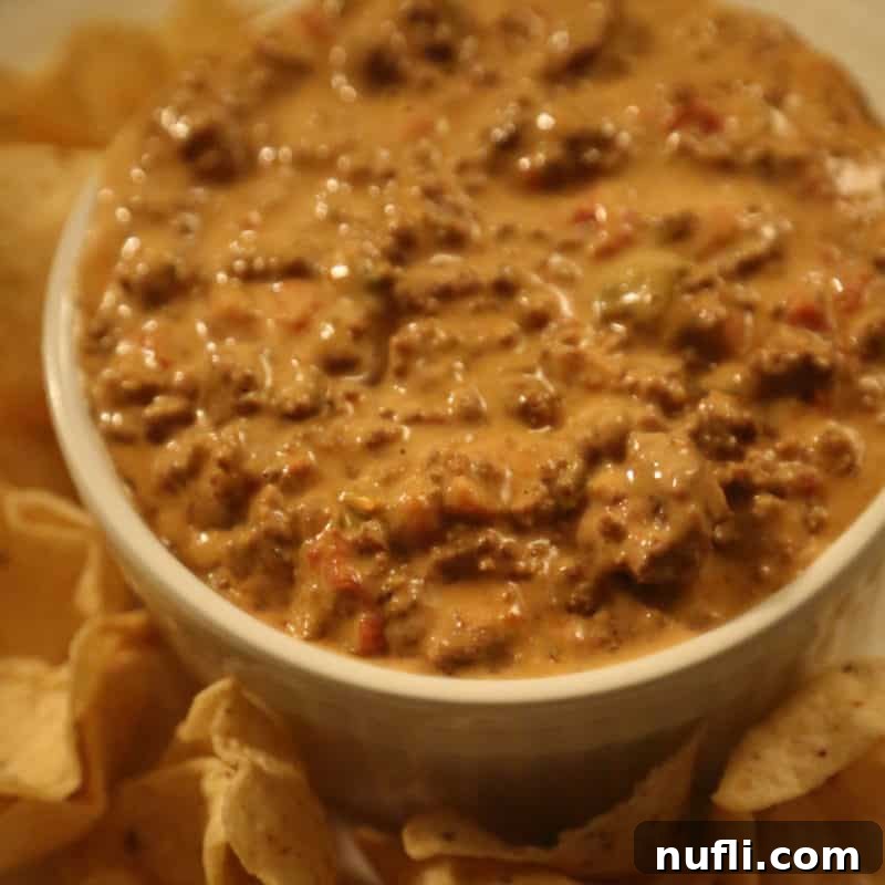 Score Big with These Game Day Appetizers 25 Crock Pot Chili Cheese Dip in a white bowl with chips on a plate