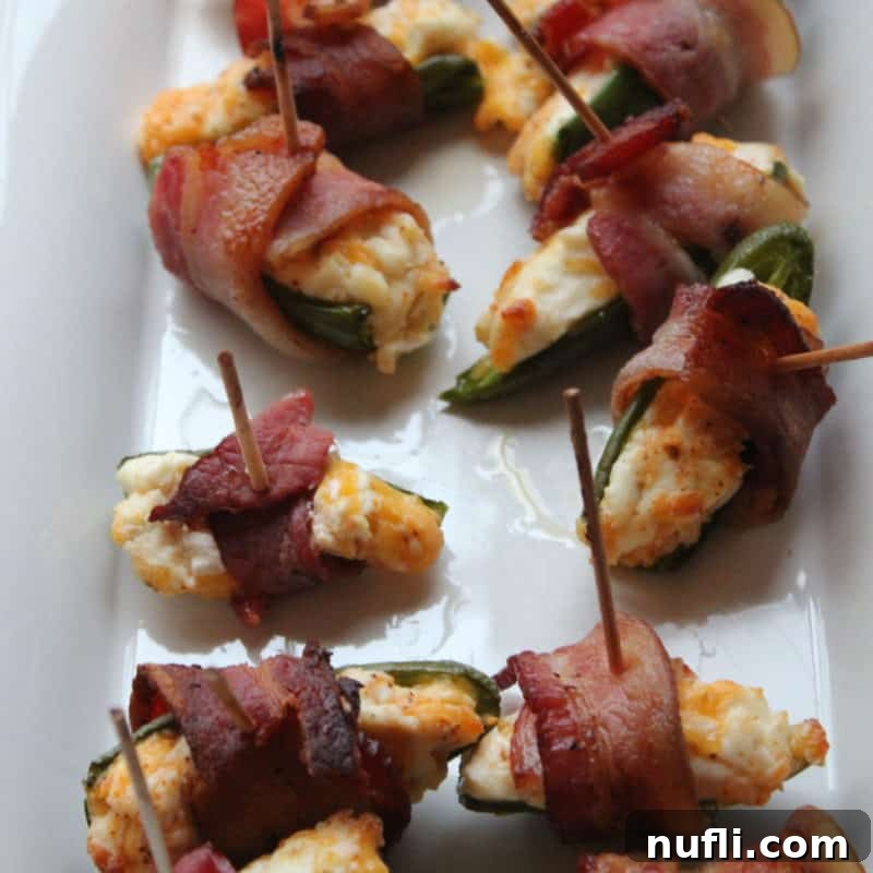 Score Big with These Game Day Appetizers 27 Bacon-Wrapped Jalapeños on a white platter