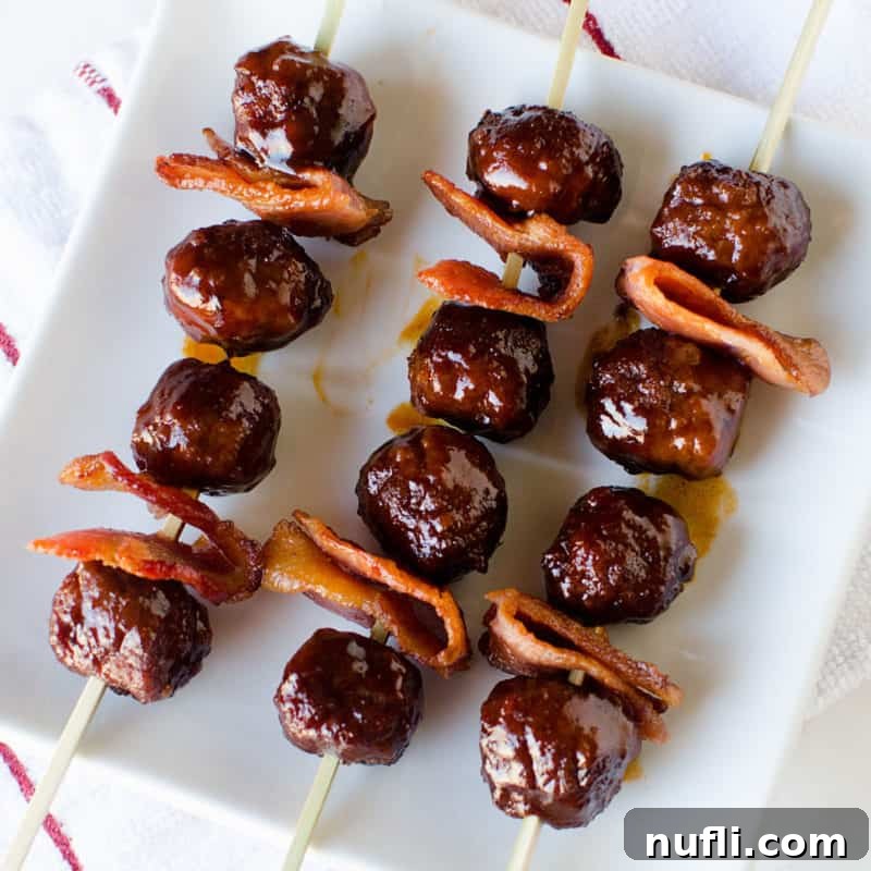Score Big with These Game Day Appetizers 38 bacon bourbon meatballs on skewers on a white plate