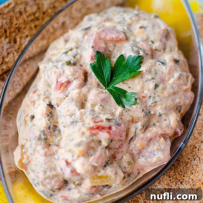 Score Big with These Game Day Appetizers 43 Crock Pot Mexican Spinach Dip in a glass dish with crackers