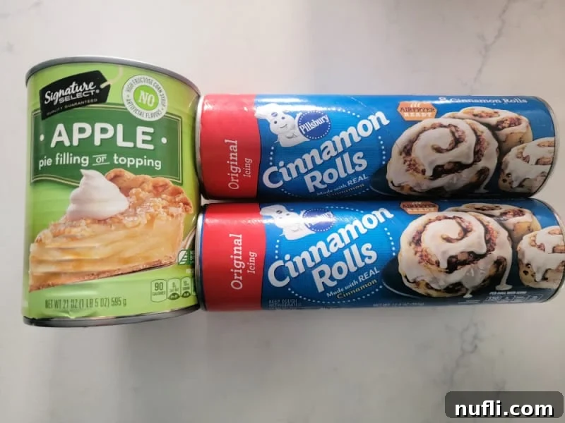 2-Ingredient Cinnamon Roll Apple Pie Bites 3 A can of apple pie filling and two cans of refrigerator cinnamon rolls, ready for baking delicious apple pie cups.