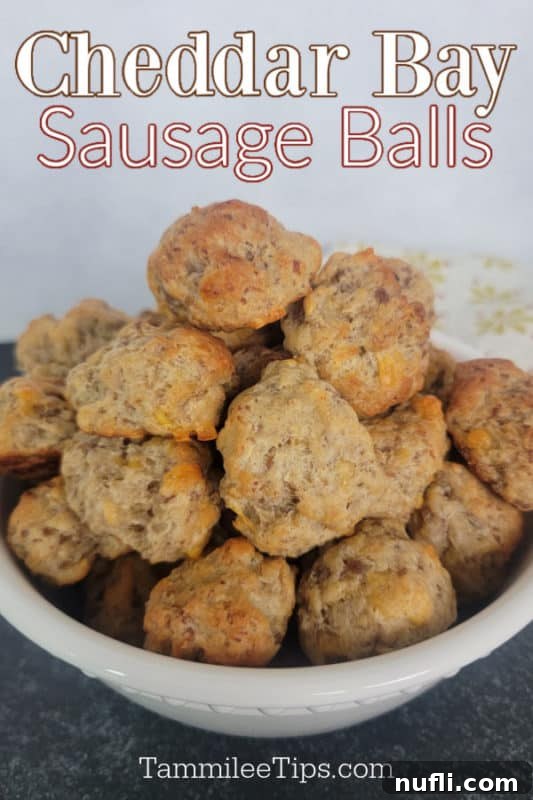 Cheddar Bay Sausage Balls text over a white bowl filled with golden-brown sausage balls, ready to be served as an easy appetizer.