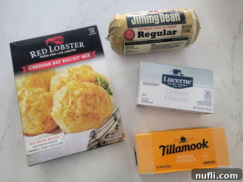 Cheddar Bay Sausage Balls ingredients cheddar bay biscuit mix, ground sausage, cream cheese, and a block of cheddar cheese