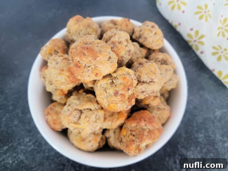 Cheddar Bay Sausage Balls in a white bowl with a cloth napkin