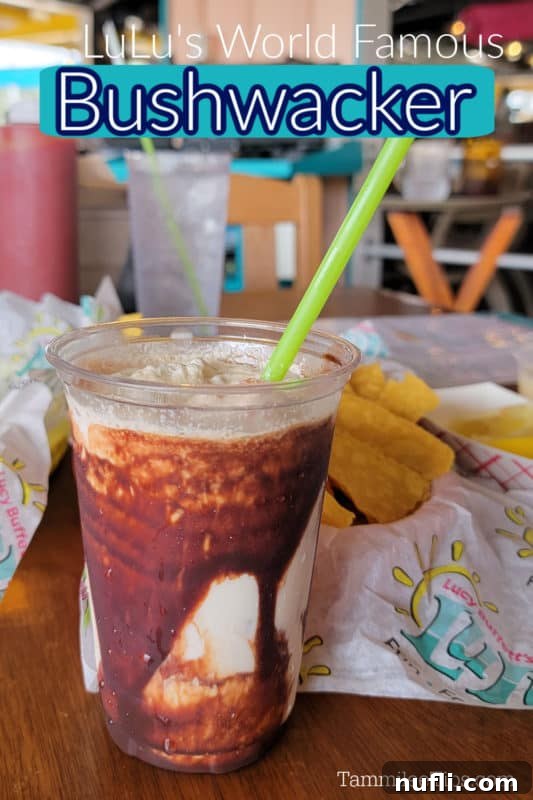 LuLu's Bushwacker text over a chocolate cream cocktail in a plastic cup