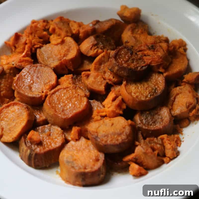 Perfectly sliced candied sweet potatoes presented in a pristine white bowl