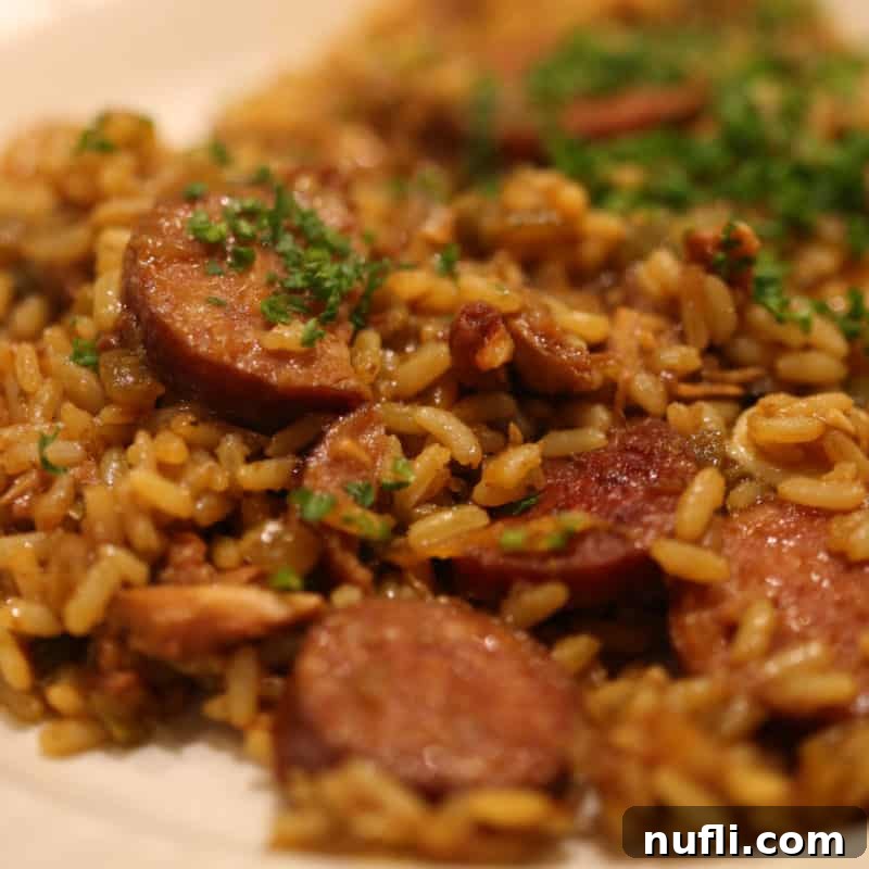 A plate of authentic Jambalaya and rice, showcasing the rich colors and textures of this New Orleans classic.