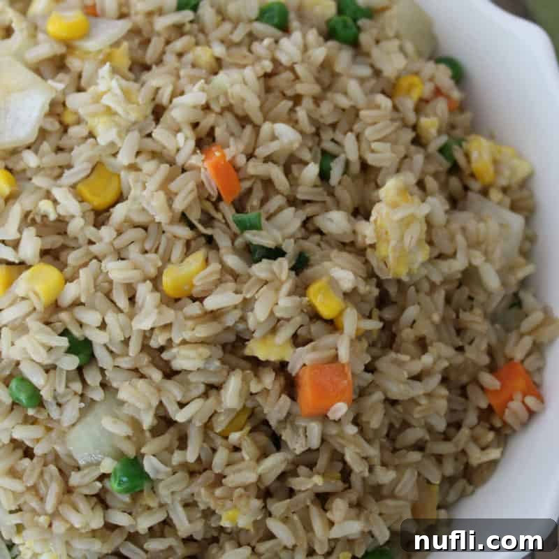 A tempting bowl of golden Fried Rice, ready to be enjoyed as a classic Asian-inspired dish.