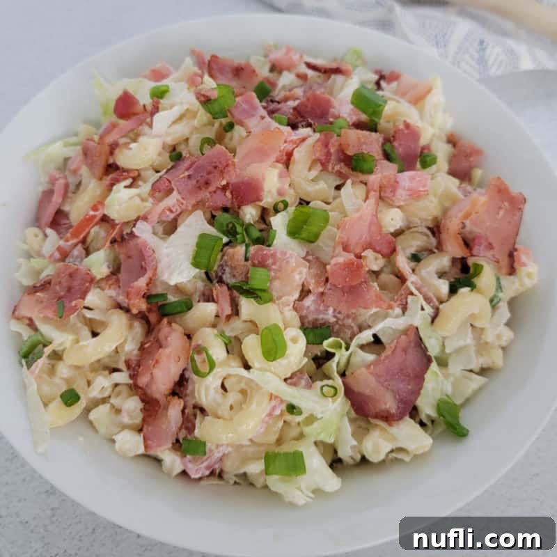 The Best Side Dishes for BBQ Ribs 23 BLT pasta salad garnished with green onion in a white bowl