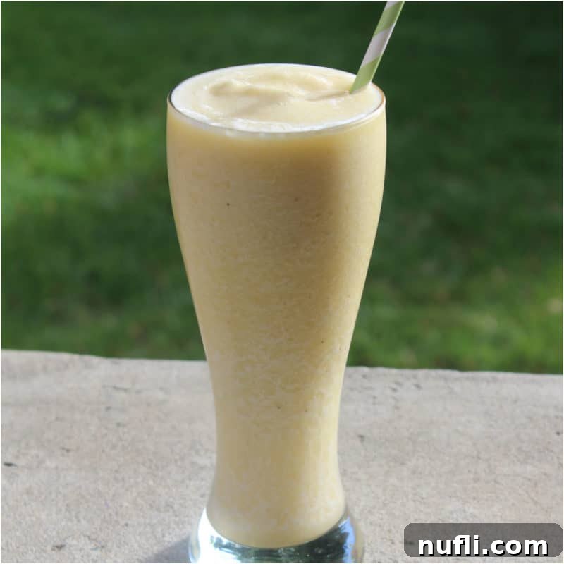 Banana Julius in a tall glass with paper straw