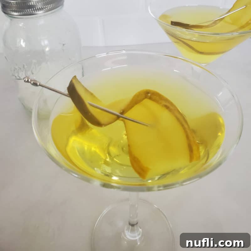 Pickle martini in a martini glass with pickle garnish