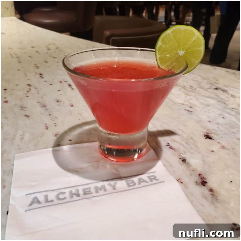 Pink 40 is the new 20 Cocktail with a lime wheel on an Alchemy Bar napkin
