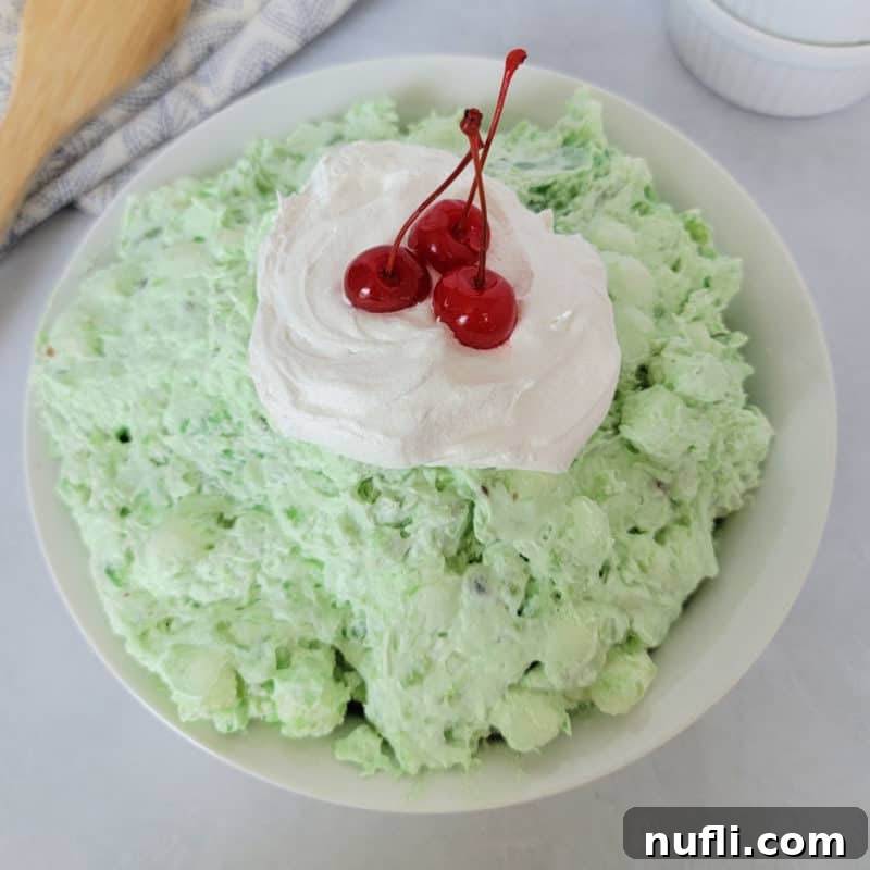 Green watergate salad with cool whip and maraschino cherries