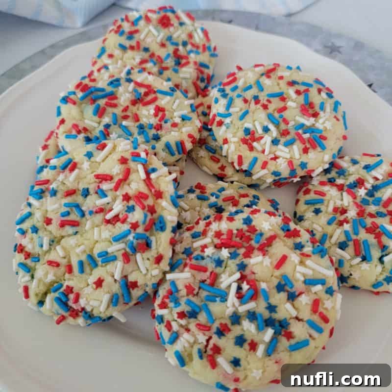 Red, White, and Blue Cake Mix Cookies piled on a white plate