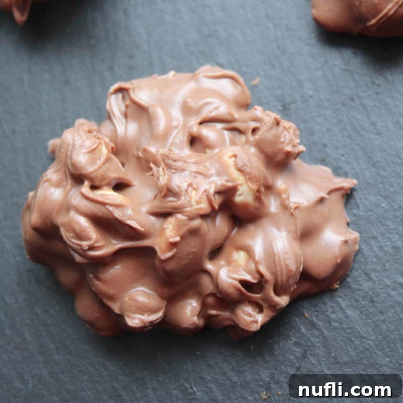 Crock Pot Chocolate Peanut Clusters on a slate board