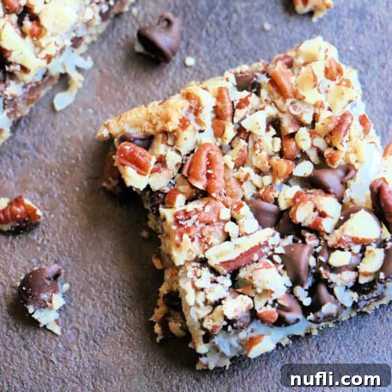 Chocolate Coconut 5 Layer Bar on a dark board