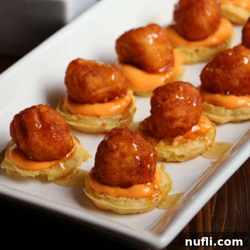 Chicken and Waffles With Spicy Dipping Sauce on a white platter
