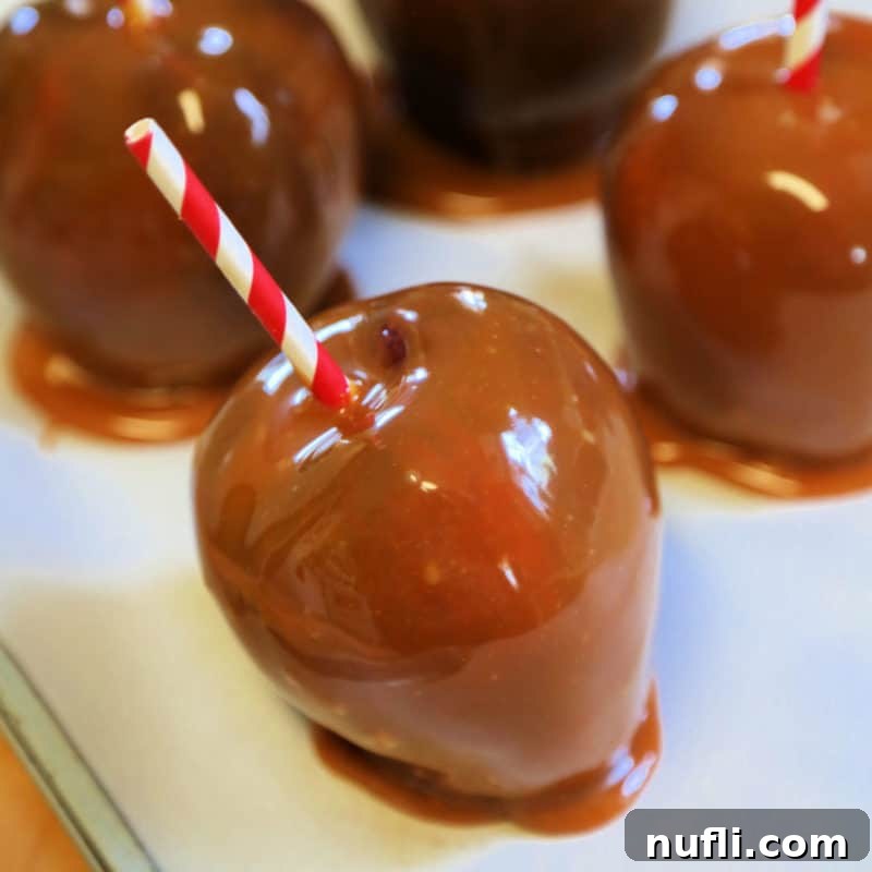 Delightful Apple Desserts Made Simple 15 Homemade CrockPot Caramel Apples on parchment paper with festive red striped paper straws