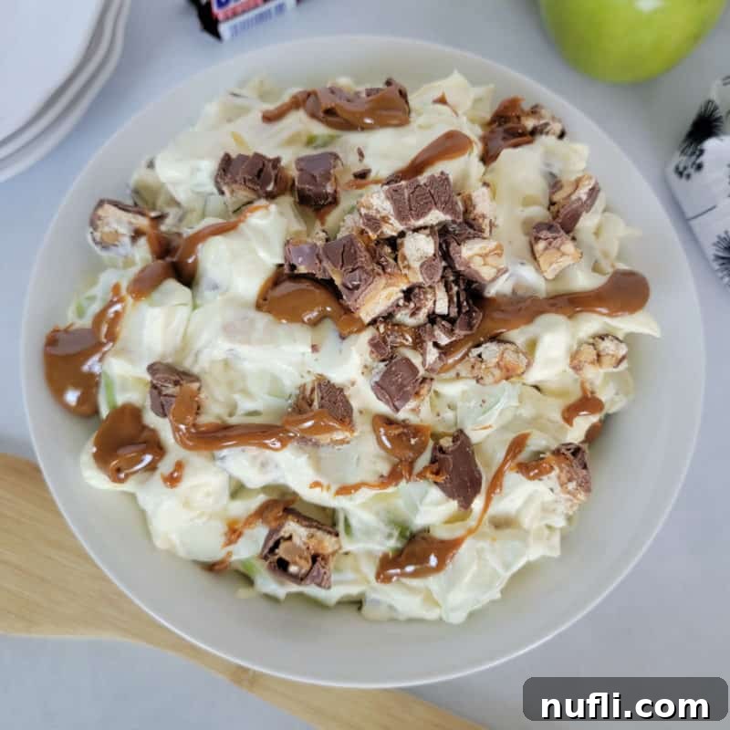 Delightful Apple Desserts Made Simple 5 Unique Apple and Snickers Salad in a white serving bowl, a popular party treat