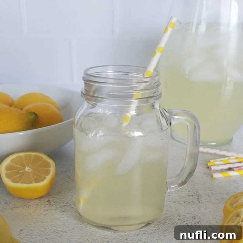 Three Ingredient Feasts Simple Scrumptious 3 Chick Fil A Lemonade in a mason jar glass in front of a pitcher and lemons