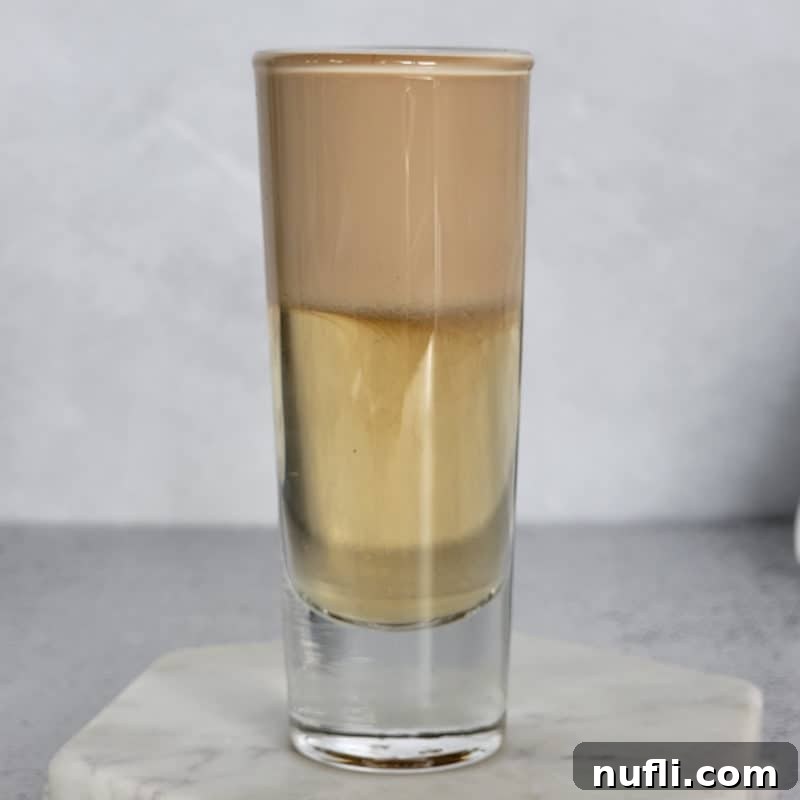 Dozens of Cozy Fall Cocktails for the Perfect Autumn 20 Nutty Irishmen Layered cocktail on a marble coaster