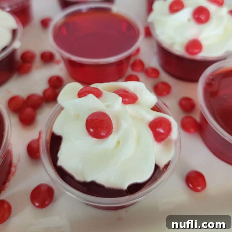 Dozens of Cozy Fall Cocktails for the Perfect Autumn 21 Fireball Jello Shot with whipped cream and a red hot candy on a white plate