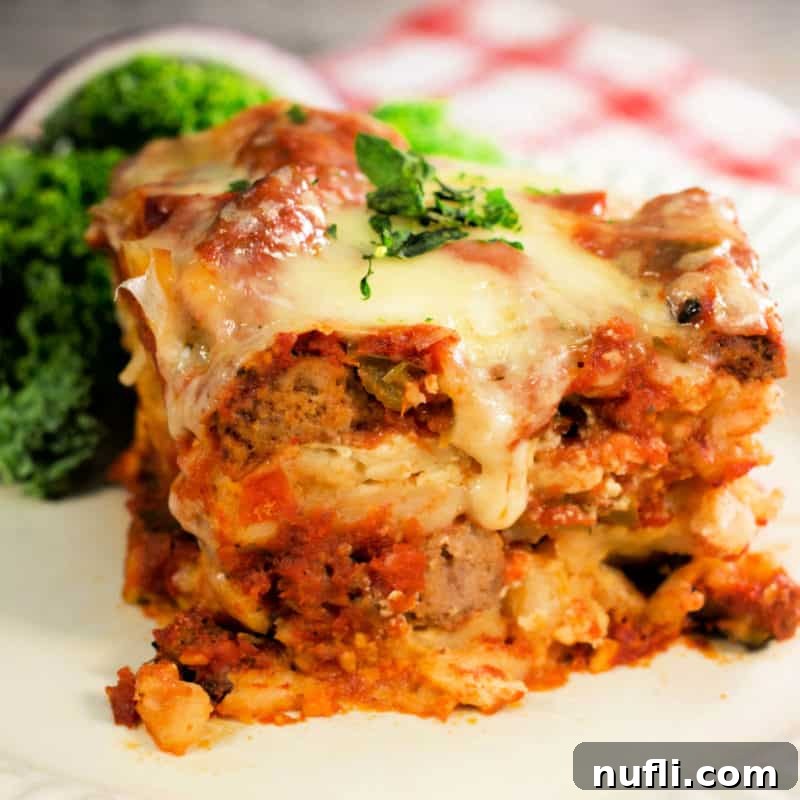 Crockpot lasagna on a white plate next to a red checkered napkin