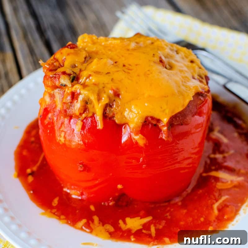 Crockpot Stuffed Pepper with cheese on a white plate next to a fork