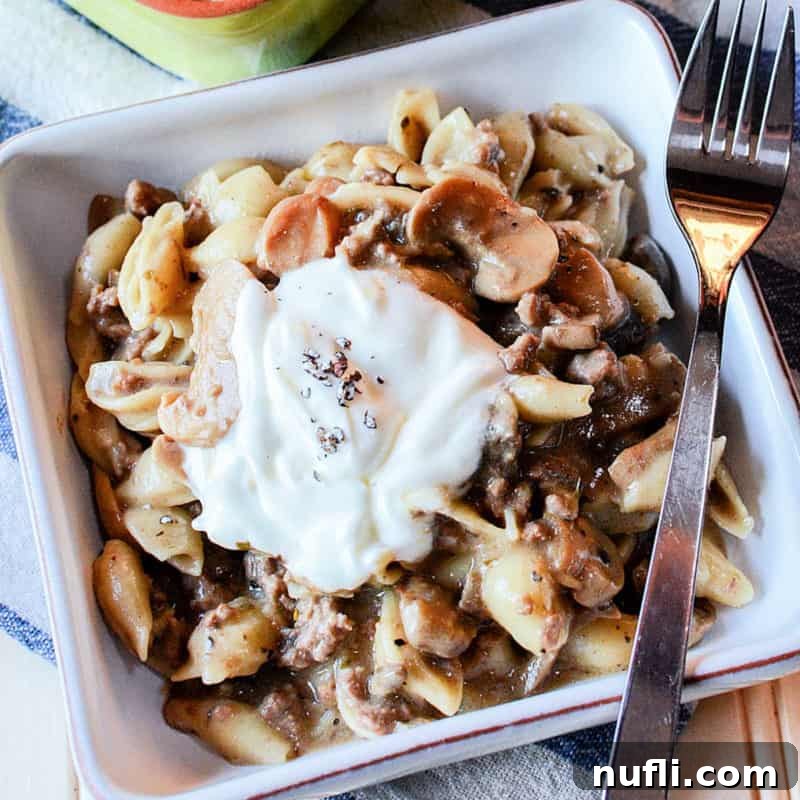 Mushroom pasta in a white square dish with a fork