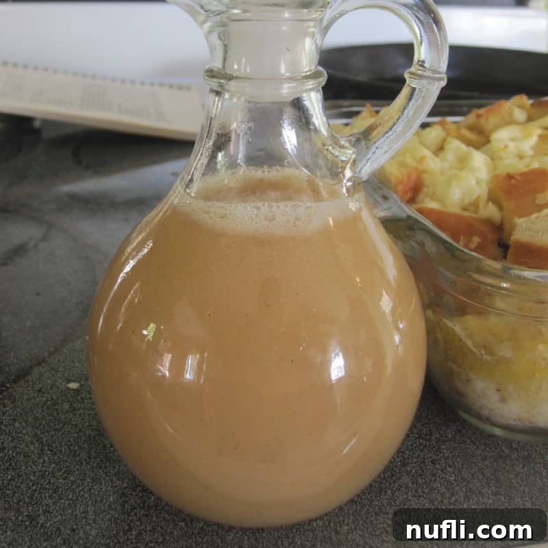 Golden Cinnamon Syrup in a clear glass container, showcasing its rich, inviting color.