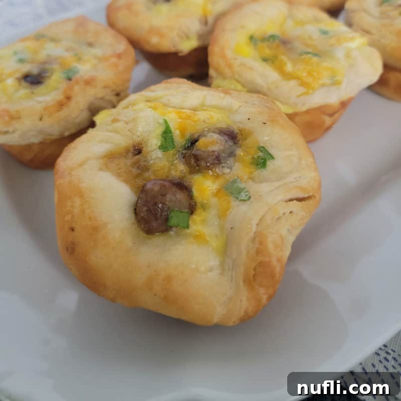 Savory Sausage Breakfast Biscuit Cups arranged on a white platter, showcasing a delightful and easy meal option.