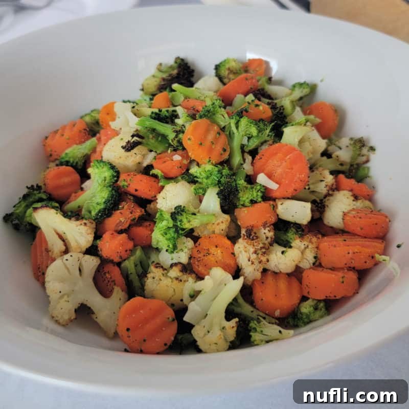 Over 30 Simple and Flavorful Vegetable Sides for Every Meal 12 vegetable mix with cauliflower, broccoli and carrots in a white bowl