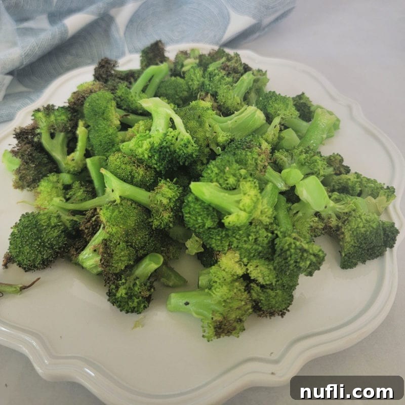 Over 30 Simple and Flavorful Vegetable Sides for Every Meal 21 air fried broccoli on a white plate