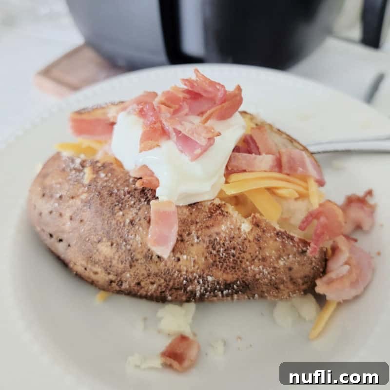 Over 30 Simple and Flavorful Vegetable Sides for Every Meal 22 Air fryer baked potato topped with sour cream, bacon, and cheddar cheese