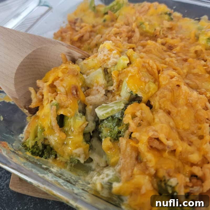 Over 30 Simple and Flavorful Vegetable Sides for Every Meal 27 Wooden spoon scooping Broccoli Casserole from a glass baking dish