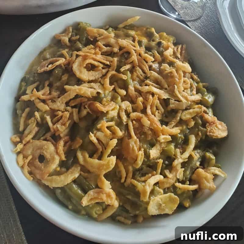 Over 30 Simple and Flavorful Vegetable Sides for Every Meal 32 fried onions on top of green beans in a white bowl