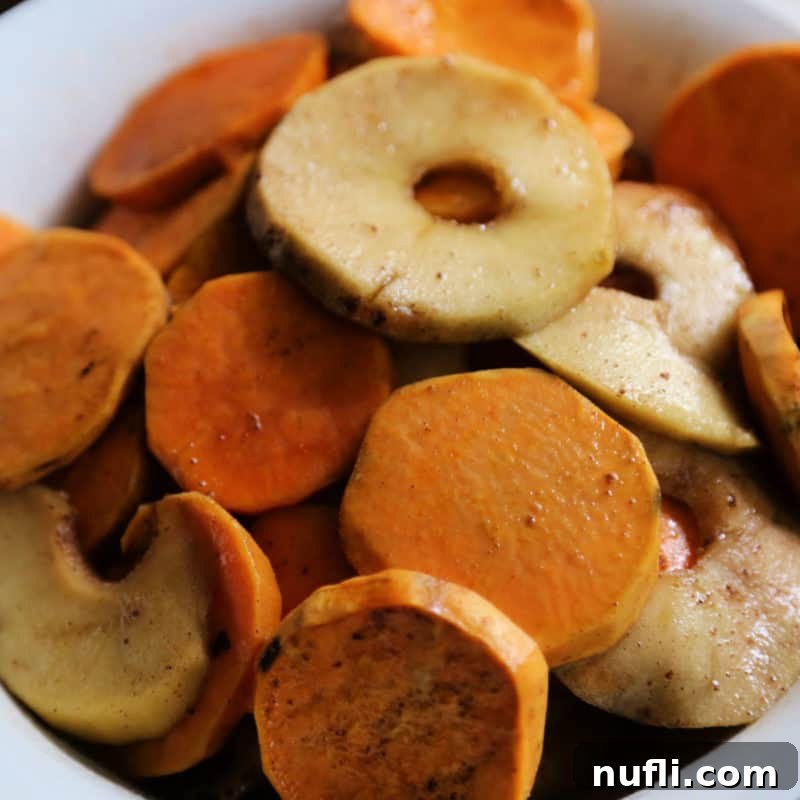 Over 30 Simple and Flavorful Vegetable Sides for Every Meal 8 Slices of sweet potatoes and apples in a white bowl